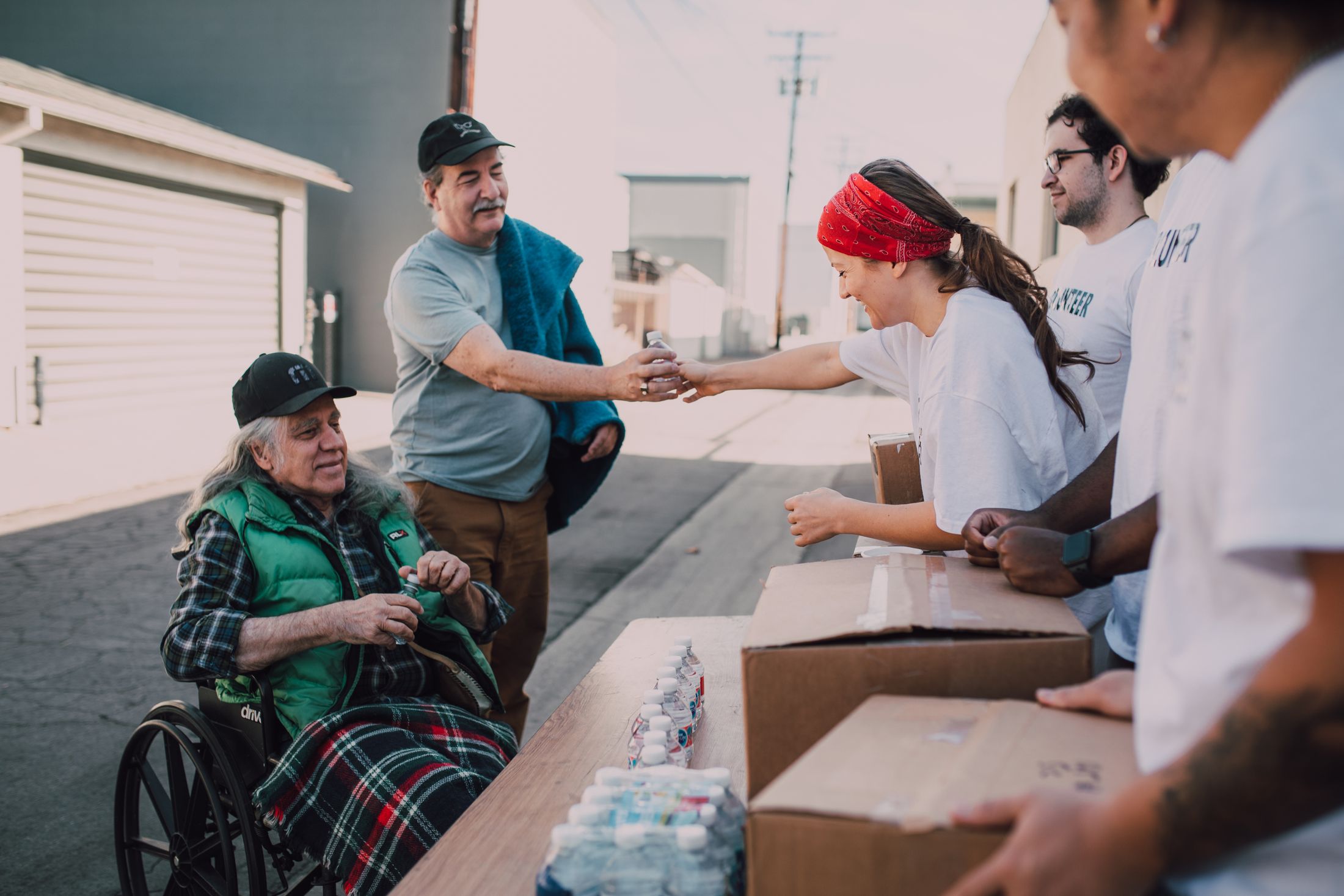 Volunteers sharing water and essential supplies with community members
